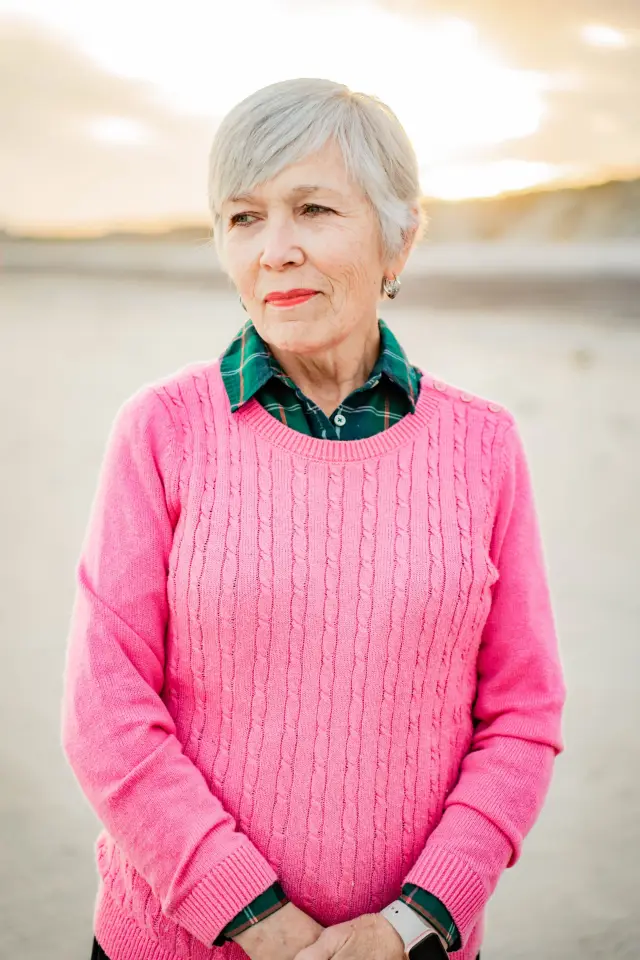Grandmother in a pink sweater portrait on the beach