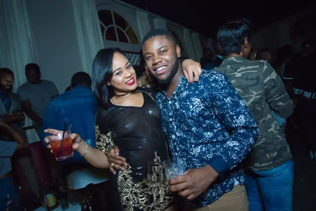 Couple smiling with drinks at a club