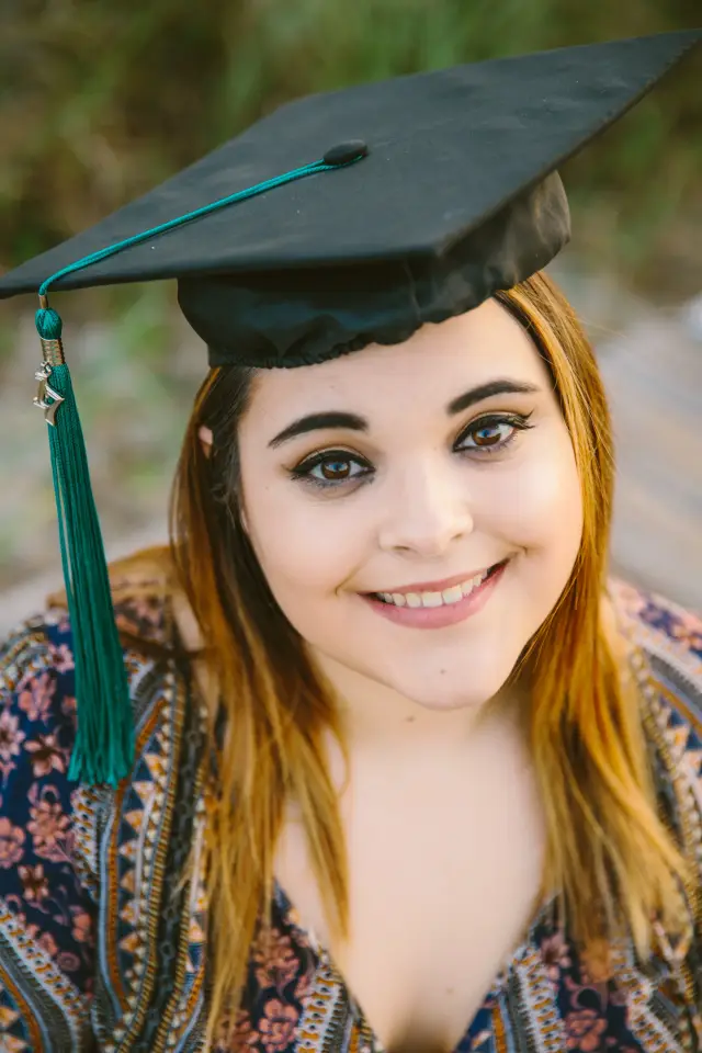Close-up of a smiling graduate in her cap and tassel