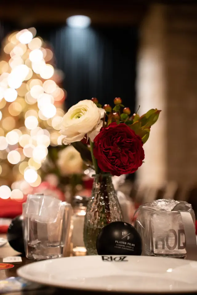 Holiday table with red and white roses and candlelight